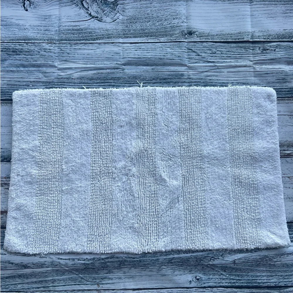 DKNY white bathroom rug 33in x 19in EUC